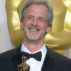 headshot: William Goldenberg holding an Academy Award